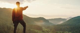 Male pointing at Sunset